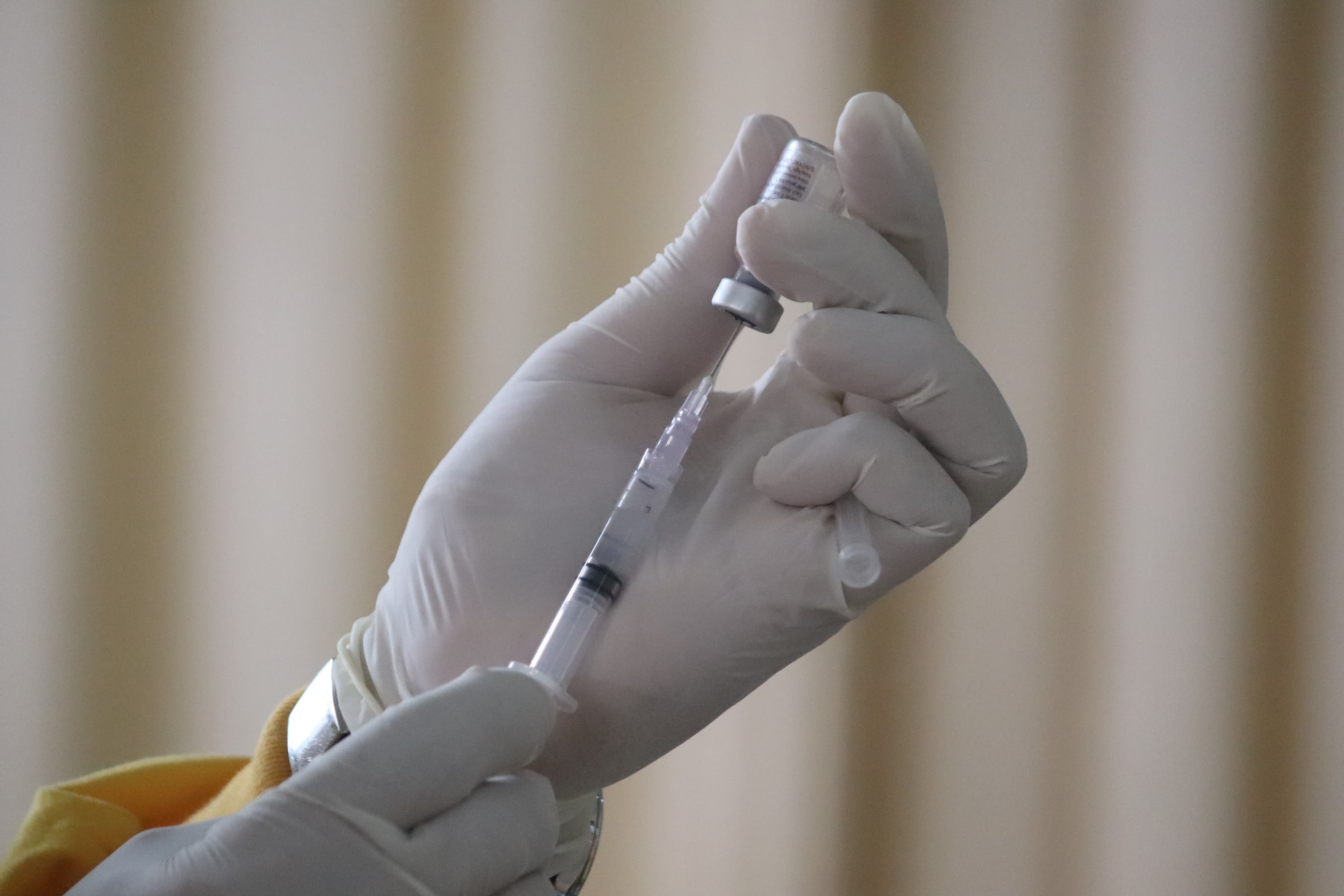 person holding syringe