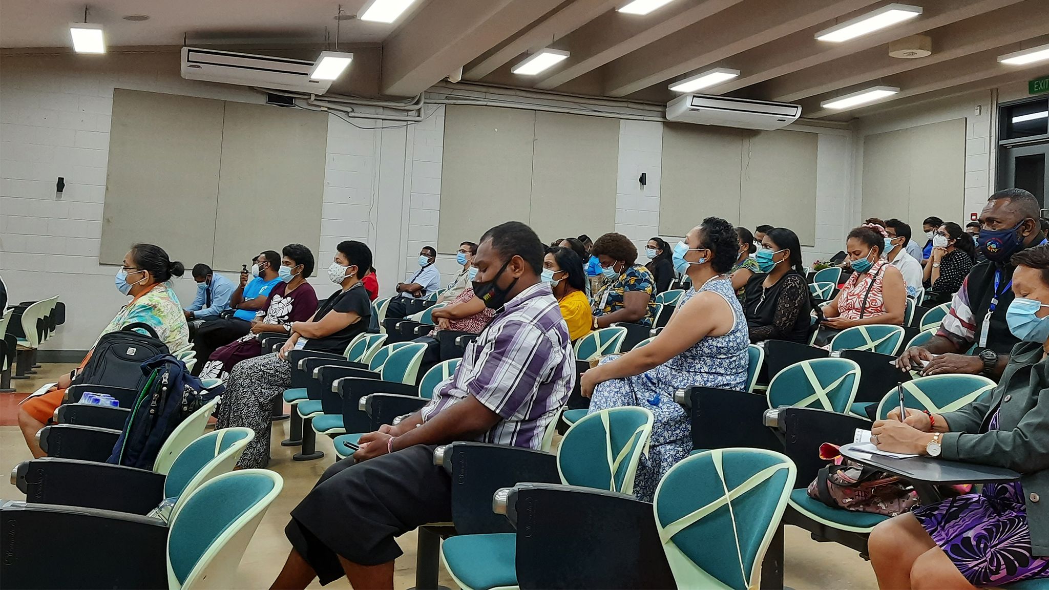 Masked crowd during seminar in Fiji