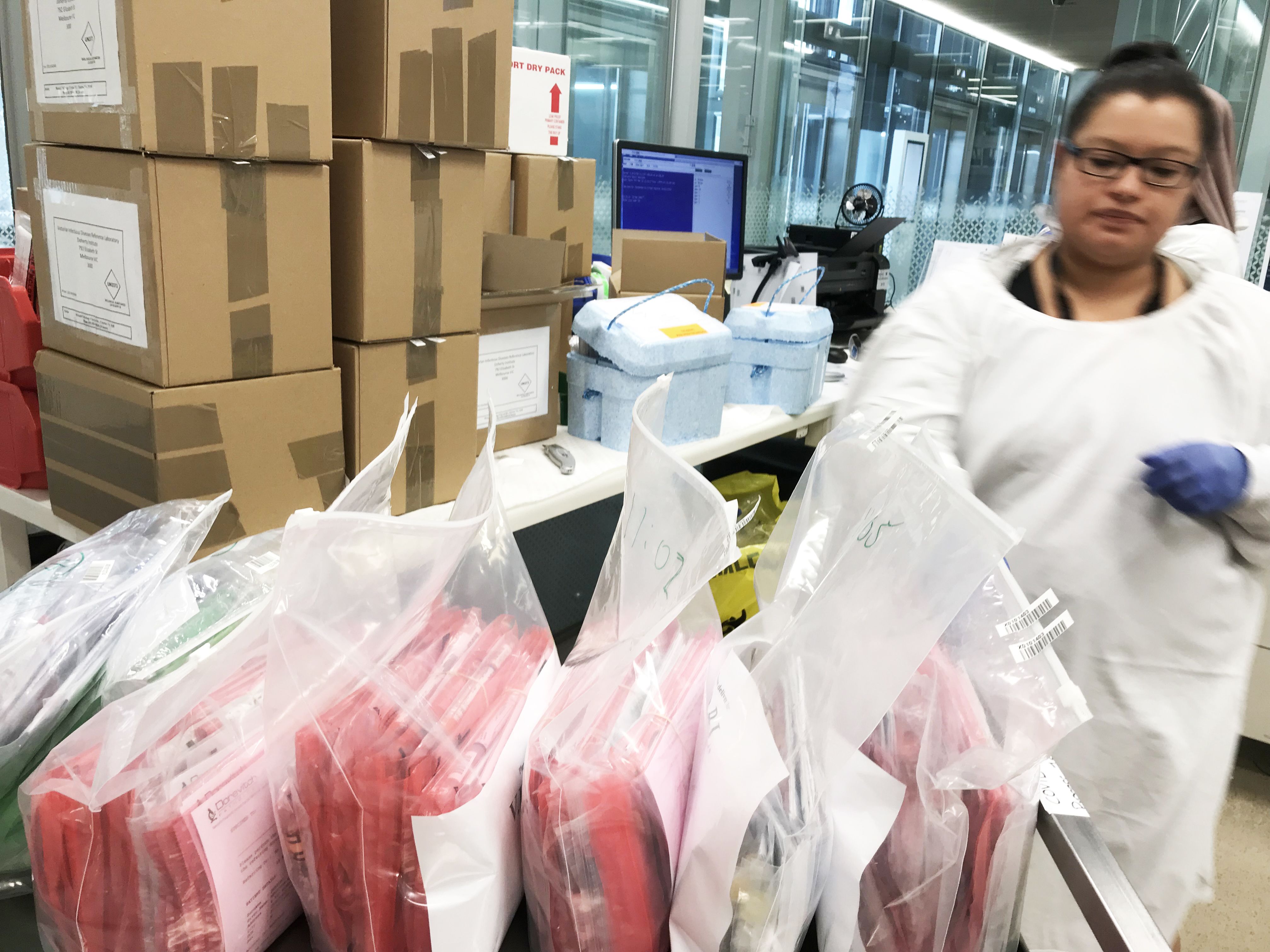 Woman in busy testing laboratory